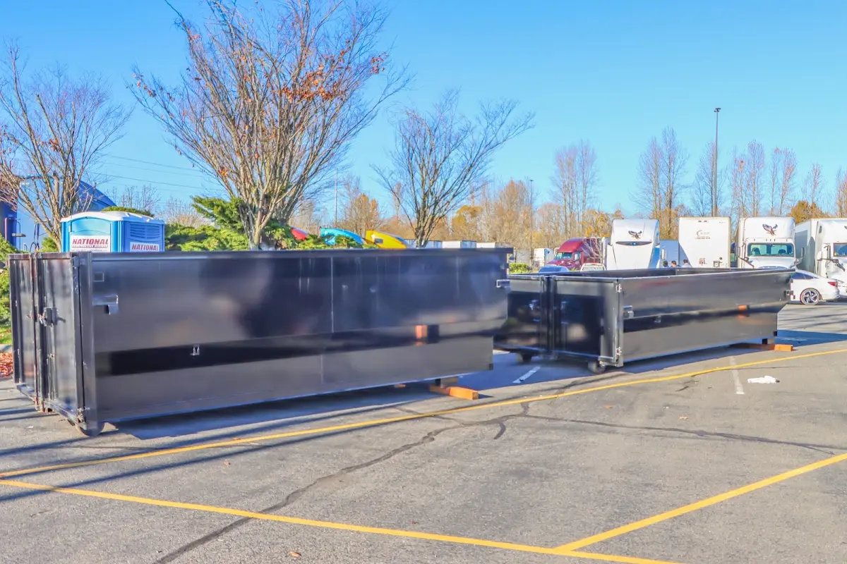 Professional dumpster rental service with roll-off container on residential driveway in Gardiner